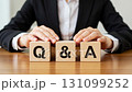 Stock video of a business scene where a person places their hand on a Q&A block 131099252