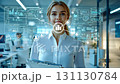 Woman scientist in hightech workspace that uses advanced technology and data visualization tools to boost productivity and collaboration among creative professionals and teams across various fields 131130784