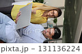 Two colleagues, staff members using laptop during meeting in office 131136224