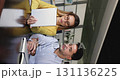 Vertical shot of two colleagues working together on digital tablet 131136225