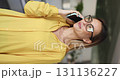 Young woman engaging in phone conversation in office 131136227