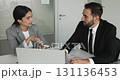 Multiethnic male female colleagues working on joint task 131136453
