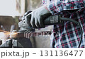 Track Shot Construction Industrial Factory or Metalwork Concept by Mechanic or Technician Using Grinder with Auto Part Workshop 131136477