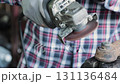 Track Shot Zoom Front View Construction Industrial Factory or Metalwork Concept by Mechanic or Technician Using Grinder with Auto Part Workshop 131136484