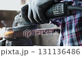 Track Shot Zoom View Construction Industrial Factory or Metalwork Concept by Mechanic or Technician Using Grinder with Auto Part Workshop 131136486