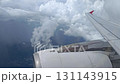 An airplane window view. The airplane wing against the backdrop of the cloud and sky. 131143915