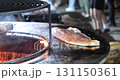 Large piece of red fish grilling at a street food festival 131150361