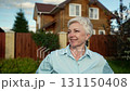 A Woman Standing at the Entrance of Her Home in a Beautiful and Picturesque Neighborhood 131150408
