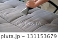 Professional cleaner hands using vacuum cleaner to refresh sofa remove stains. 131153679