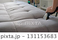 Professional cleaner cleaning use vacuum cleaner to clean dirt stains from sofa. 131153683