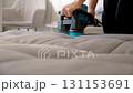 Cleaning service maid worker using electric brush machine cleaning sofa. 131153691