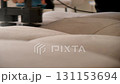 Cleaning service worker removing stains from sofa using electric brush. 131153694