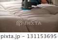 Cleaning service removing stain from sofa using electric brushing machine. 131153695