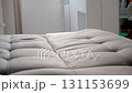 Cleaning service worker removing stain washing spraying sofa in clients home. 131153699