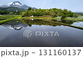 代搔き前の田んぼの水面に映る山 131160137