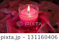 Glowing pink candle with heart shaped decorations creating romantic mood on soft fabric., 4k video 131160406