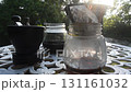 Manual Coffee Brewing Setup with Grinder, Jar, and Filter on Outdoor Table. 131161032