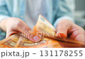 Woman counting euro bills, close-up 131178255