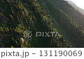 Lush green valley and river winding through mountain forest 131190069