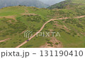 Black suv driving on a mountain dirt road 131190410