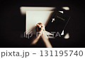 A Christian praying and meditating with his hands clasped together, with the cross of Jesus Christ and the Holy Bible in the background. 131195740