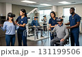 Patients engage in virtual reality training to enhance their skills with prosthetics. Therapists support their progress while monitoring their movements and adjusting techniques as needed. 131199506