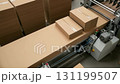 Cardboard boxes are being efficiently assembled and folded by machines in a production facility. The process showcases the use of eco friendly materials and organized workflows. 131199507