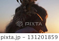 Young female model in autumn outfit posing against sunset background in mountains 131201859