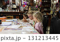 Three triplet sisters are painting at the table 131213445