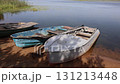 old Boats on the shore of a large lake 131213448