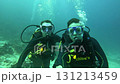 Husband and wife go diving in the sea 131213459