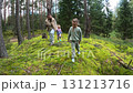 Mom and three little daughters go to the forest for mushrooms 131213716