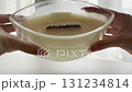 Large scented candle in glass jar, woman hands holding, cozy autumn home comfort and warm hygge lifestyle 131234814