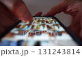 Close up of fingers touching and scrolling on mobile application. On a white background. Internet browsing, Social media marketing. Blurred macro. Top view dark shot 131243814