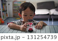 A child watches as time slips away with an hourglass 131254739