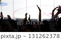 Cheering crowd silhouettes celebrate a victory at an ice hockey game. 131262378