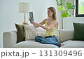 Young woman using digital tablet for video call, online chat conference sitting at home 131309496