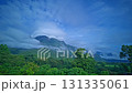 Time lapse A breathtaking view of lush green mountains shrouded in low-hanging clouds, creating a mysterious and serene atmosphere.The clouds on the mountaintop kept changing shape. 131335061