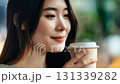 Close-up of a woman calmly drinking hot coffee 131339282