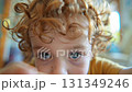 A video of a little boy using the phone. A curly toddler touching the screen with his hands. 131349246