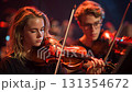 Musicians playing violin during a concert on stage 131354672