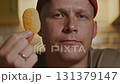 Man eating chip in close up with calm evening home atmosphere 131379147
