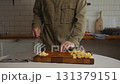 Man calmly chopping cheese for meal 131379151