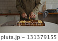 Man calmly slicing cheese in home kitchen 131379155