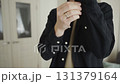 Close-up of man adjusting cuff in minimalist style 131379164