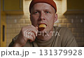 Close up of man holding chip in calm evening kitchen ritual 131379928