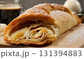 Deliciously Baked Apple Strudel, Golden Pastry Rolled with Sweet Apples and Topped with Powdered Sugar, Served with a Scoop of Vanilla Ice Cream and a Cup of Coffee. 131394883
