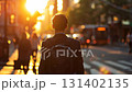 Back view of young successful man walking around the city streets 131402135