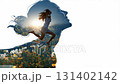 Video montage of two superimposed footages on a white background. Woman is jumping happily in a field of flowers is over the profile view of a happy looking female head 131402142