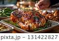 Delicious roasted turkey with golden skin served with green beans and cheesy potatoes. Perfect festive Thanksgiving dinner table scene with warm holiday atmosphere 131422827